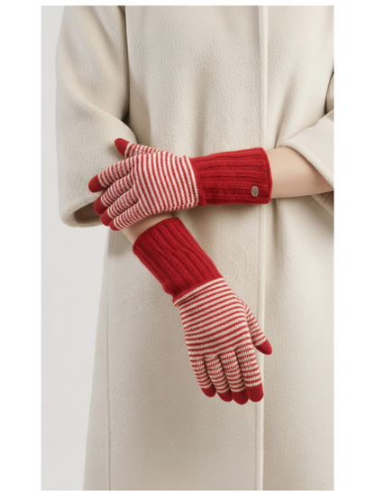 Red striped knit gloves worn with a cream coat