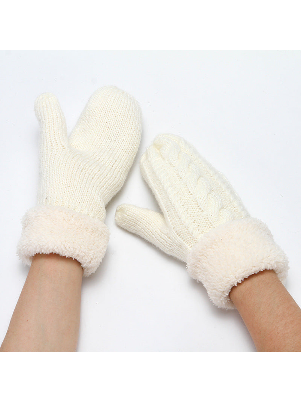Ivory cable-knit mittens with plush cuffs worn against a white background