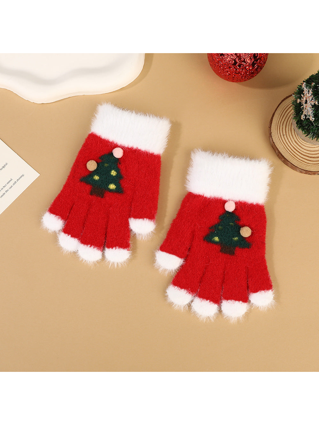 Red fuzzy fingerless gloves with white trim and Christmas tree motifs