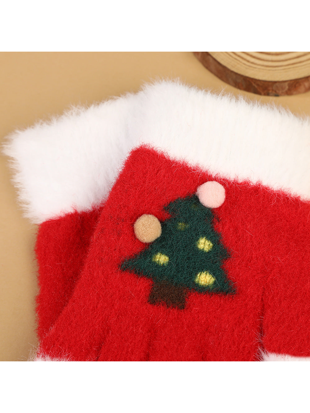 Close-up of the fuzzy Christmas tree motif and raised pom-pom details