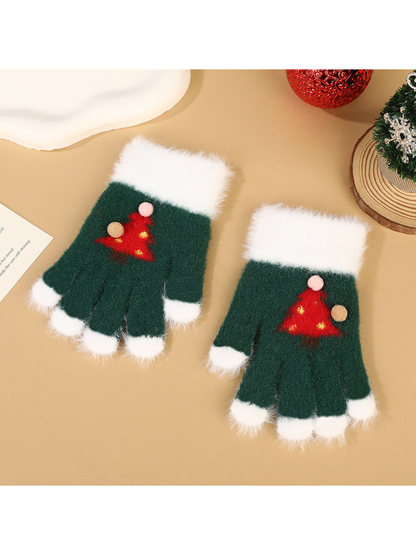 Green fuzzy fingerless gloves with white trim and red Christmas tree motifs
