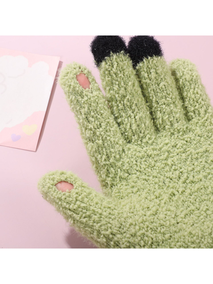 Close-up of openings on selected fingertips of the green gloves