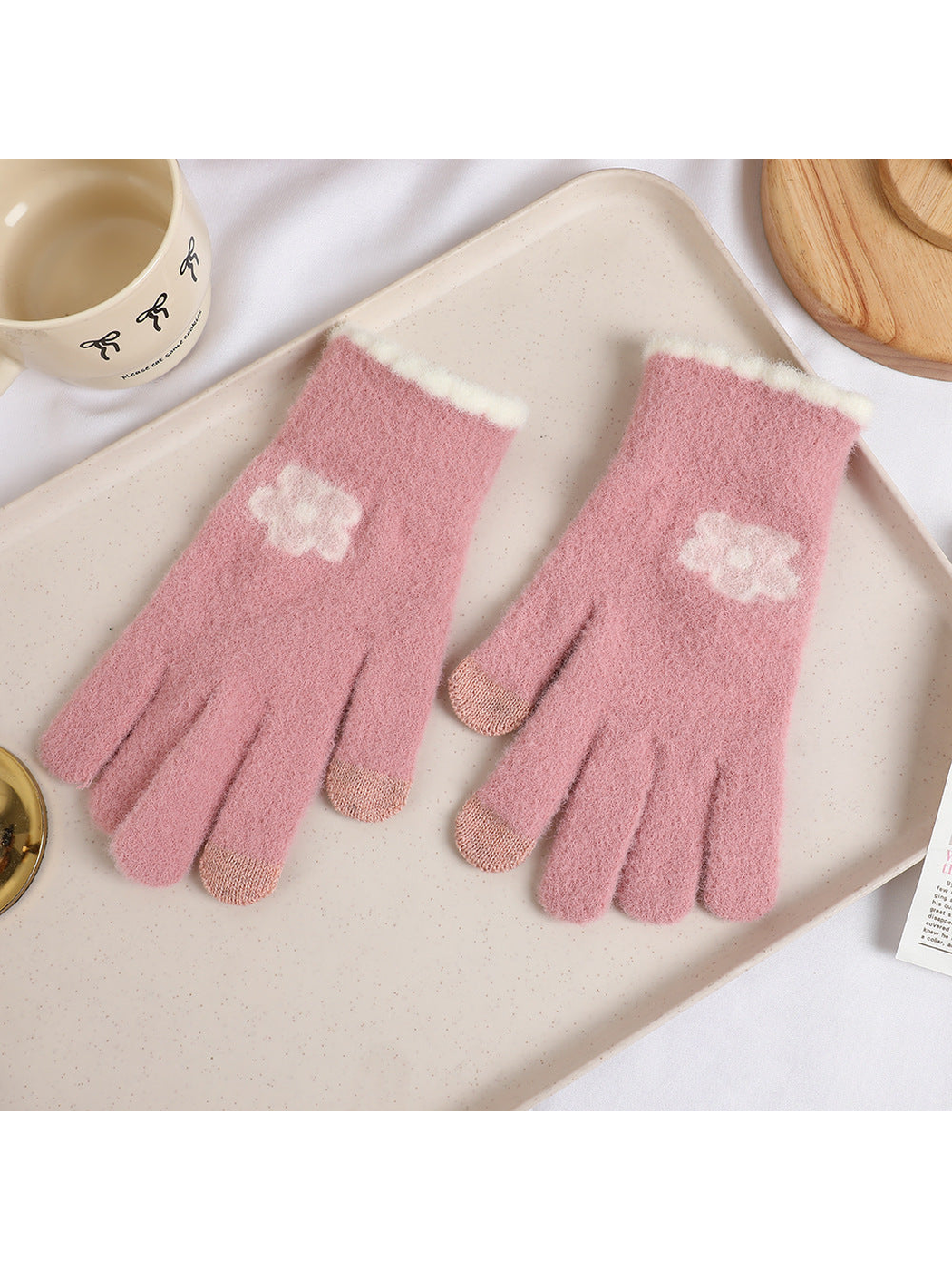 Dusty pink fuzzy gloves with white flower motifs and contrasting fingertips
