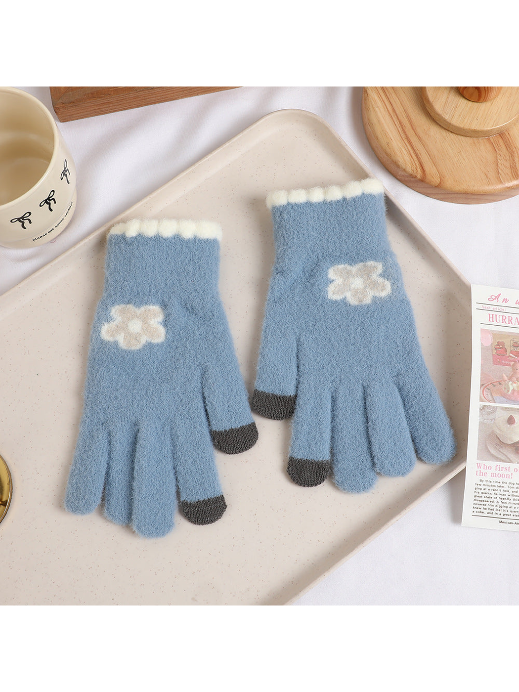Gray-blue fuzzy gloves with cream flower motifs and dark fingertips