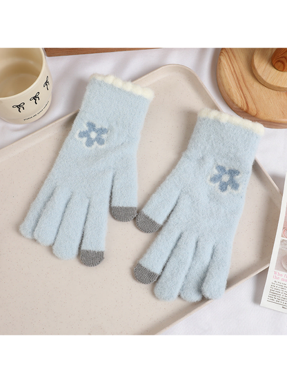 Light blue fuzzy gloves with blue flower motifs and gray fingertips