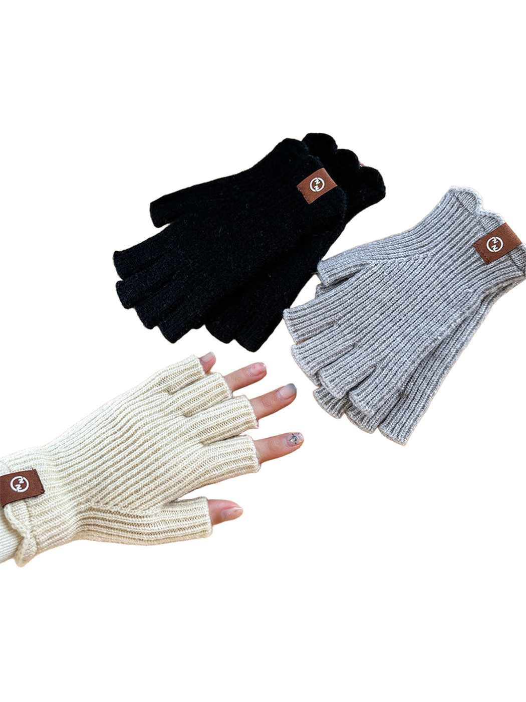 Black, gray and ivory ribbed fingerless gloves displayed together