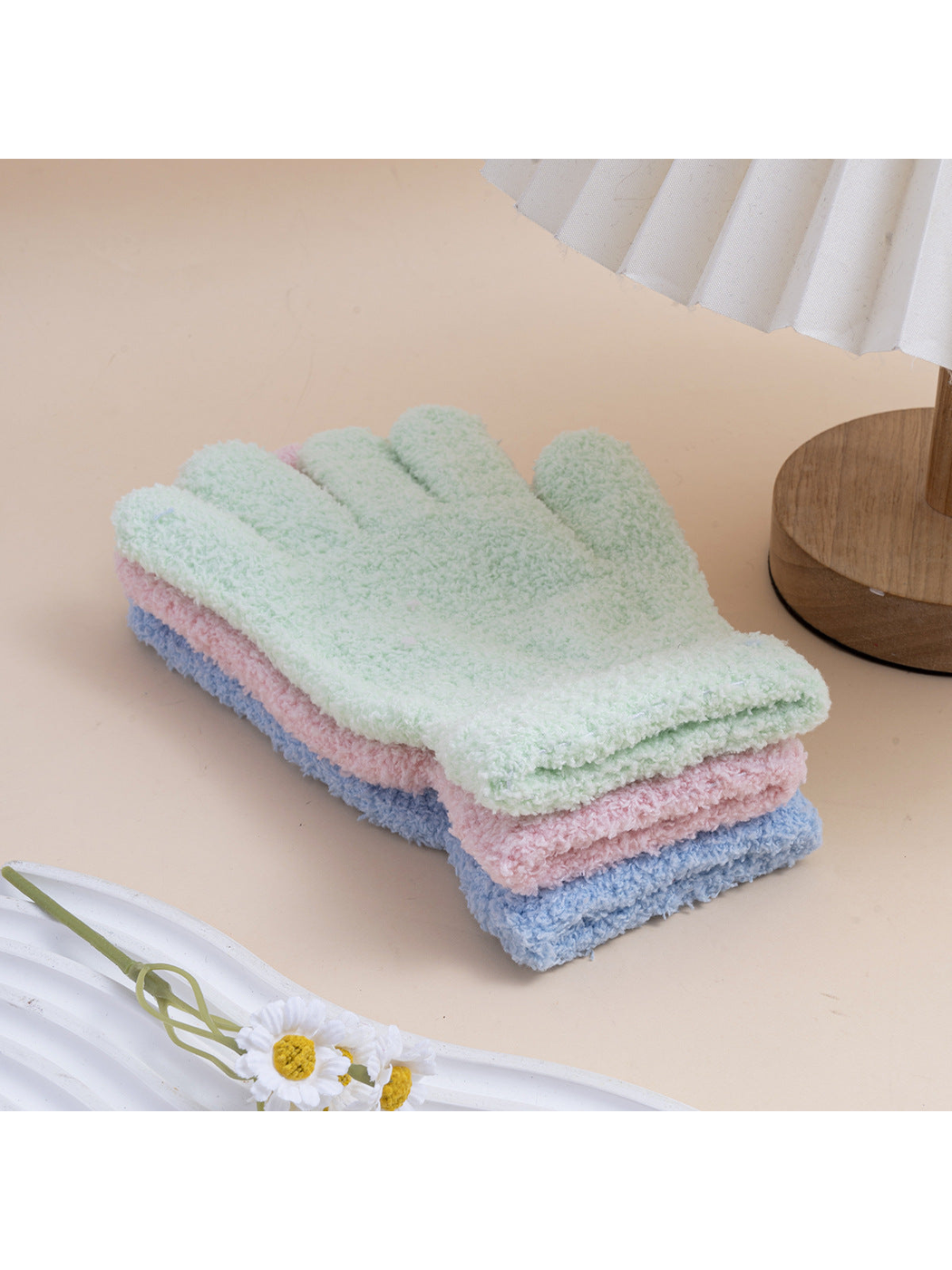 Mint, pink and light blue fuzzy gloves stacked together