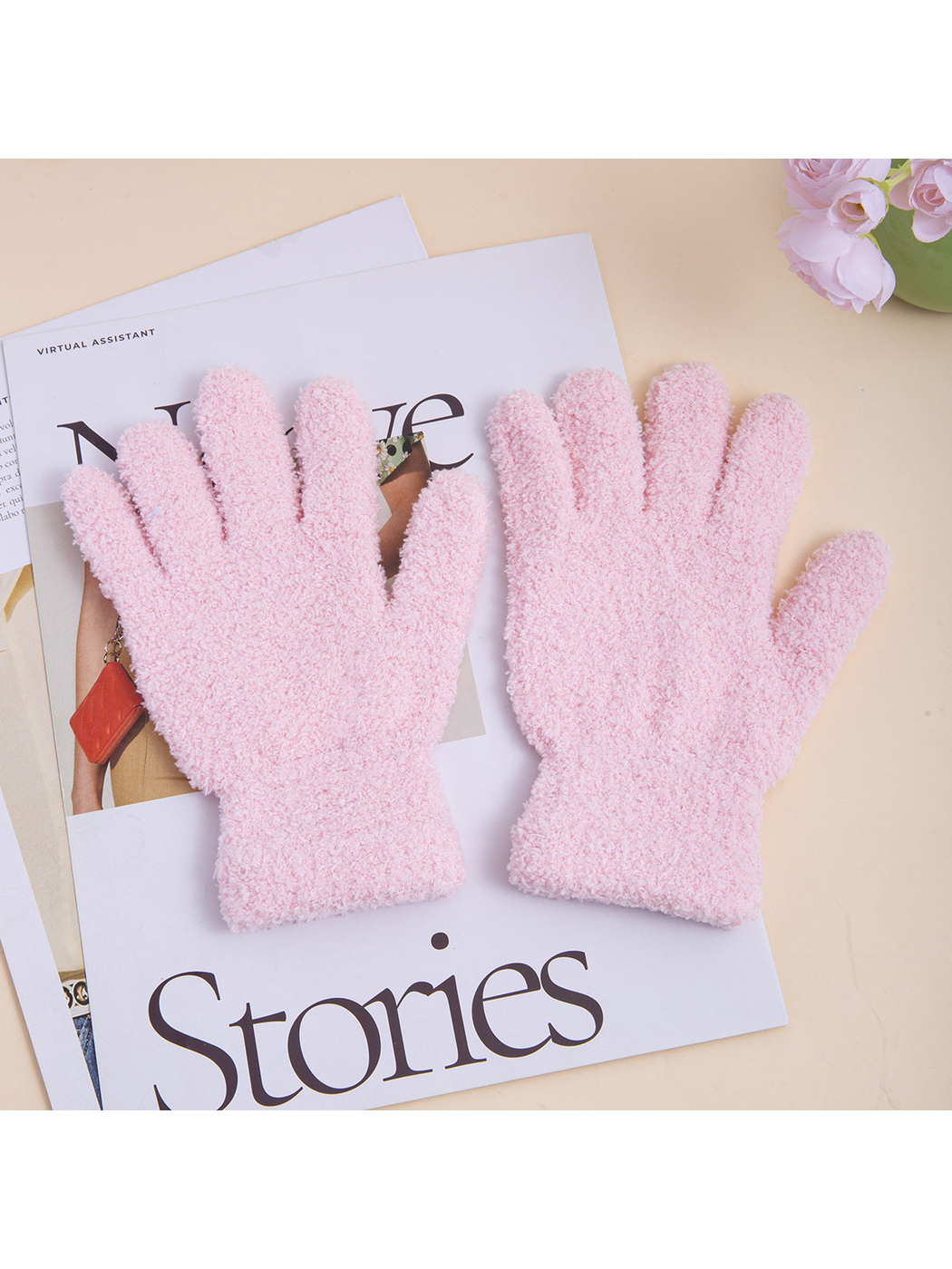 Pair of light pink fuzzy five-finger gloves with extended cuffs