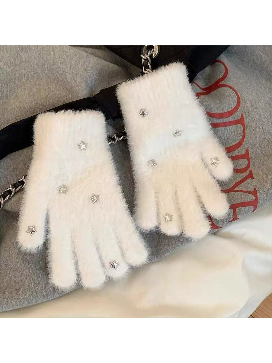 White fuzzy star gloves styled on a gray outfit