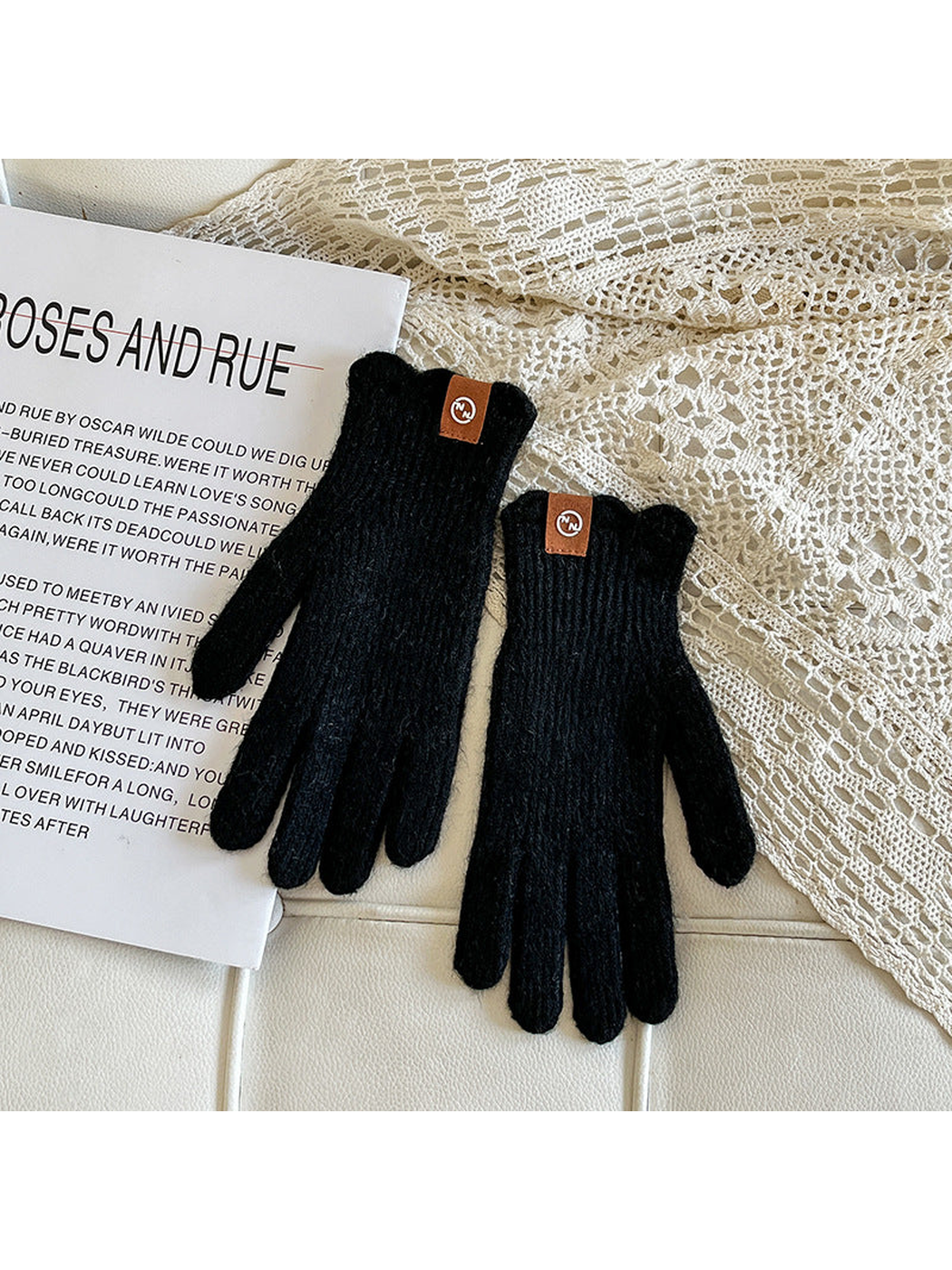 Black ribbed gloves with brown cuff logo patches