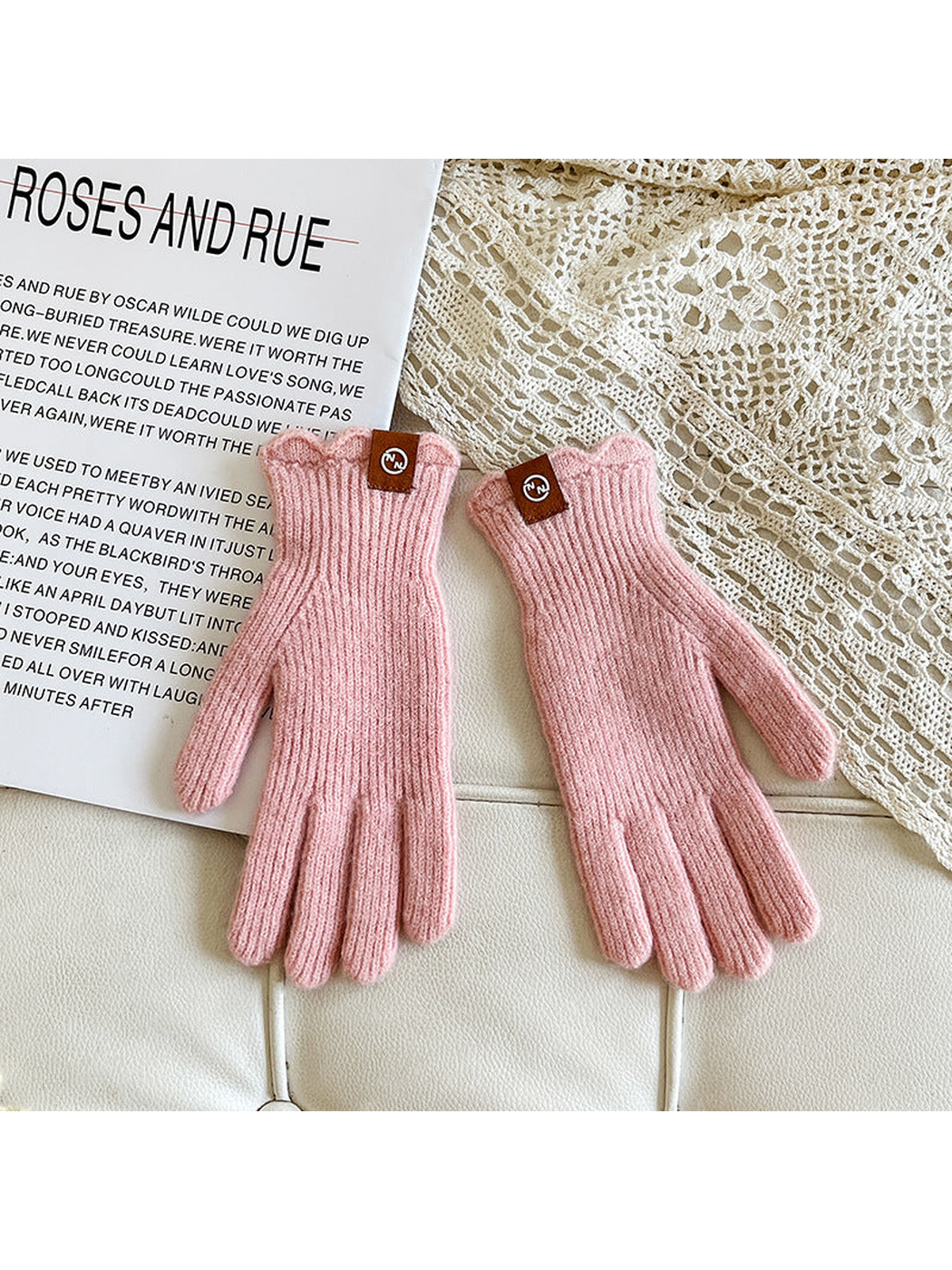 Light pink ribbed gloves with scalloped cuffs and logo patches