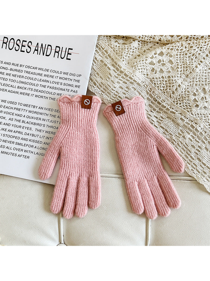 Light pink ribbed gloves with scalloped cuffs and logo patches