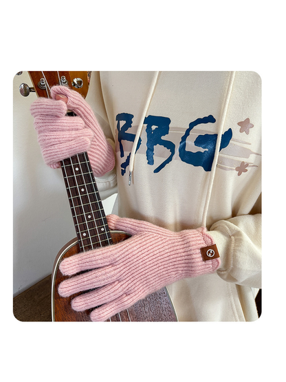 Light pink ribbed gloves worn while holding a small guitar