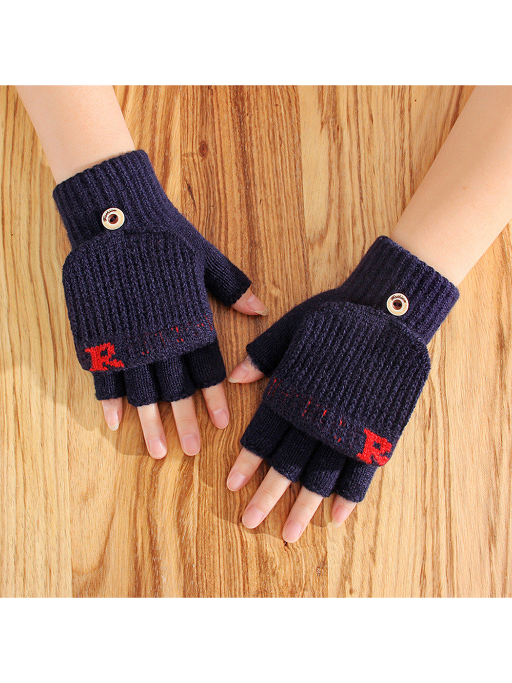 Navy convertible mittens worn with the fingertips exposed