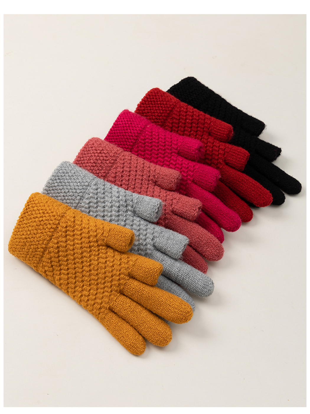Assorted solid-color textured gloves arranged in a diagonal stack