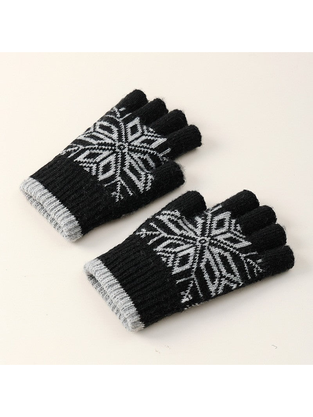 Black fingerless gloves with gray snowflake motif, angled front view