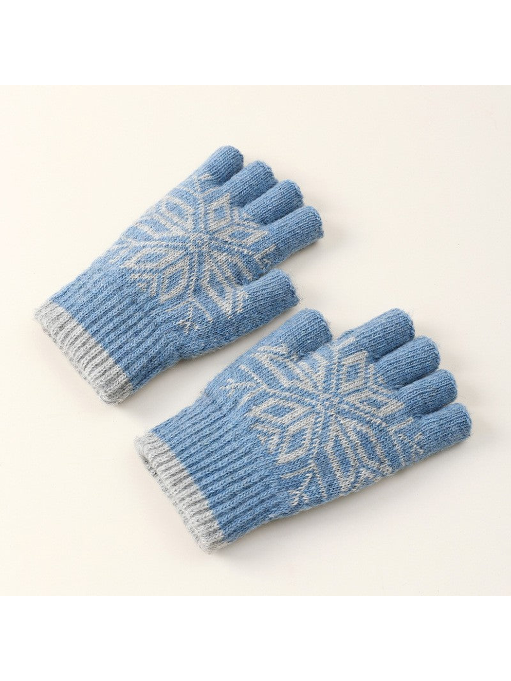 Blue fingerless gloves with pale snowflake motif, angled front view