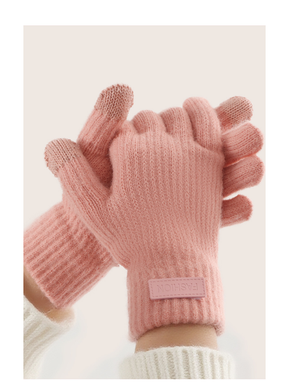 Pink ribbed gloves worn with the hands clasped