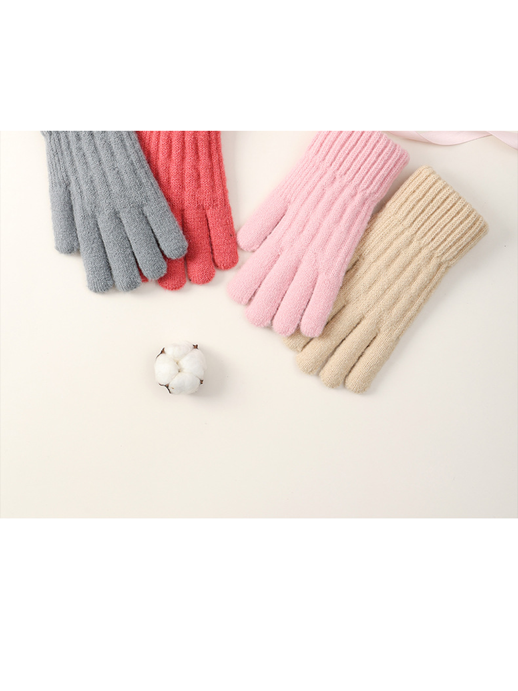 Gray, red, pink and beige textured knit gloves arranged together
