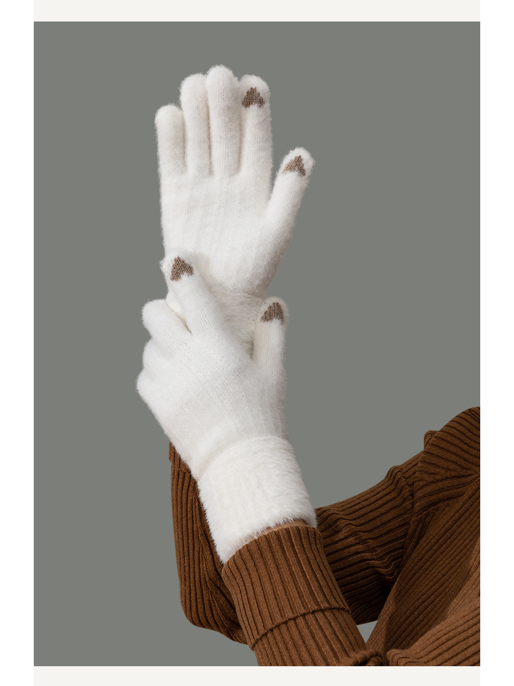 White fuzzy-textured gloves worn with a brown ribbed sweater