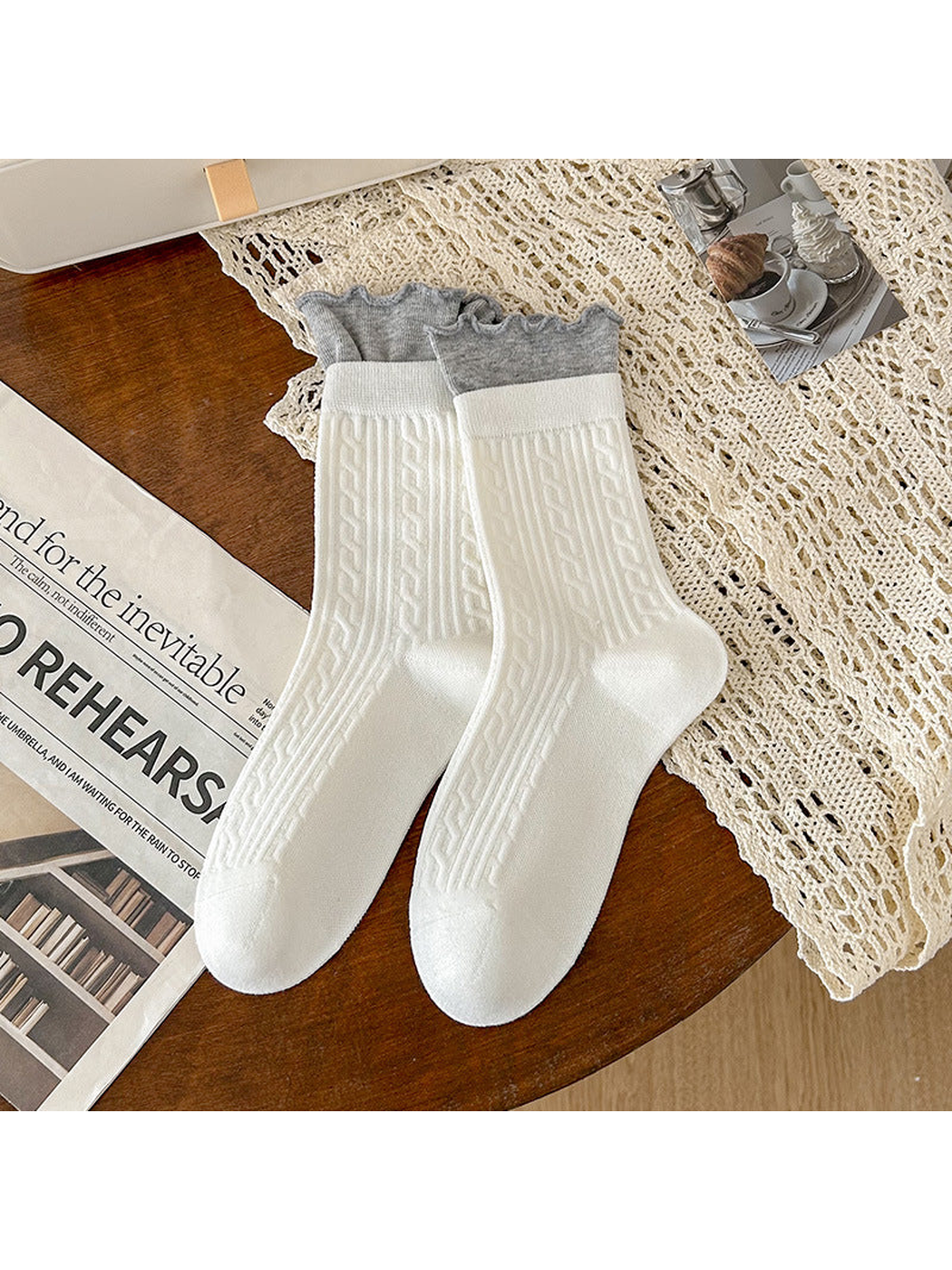 White crew socks with gray ruffled cuffs and ribbed geometric texture