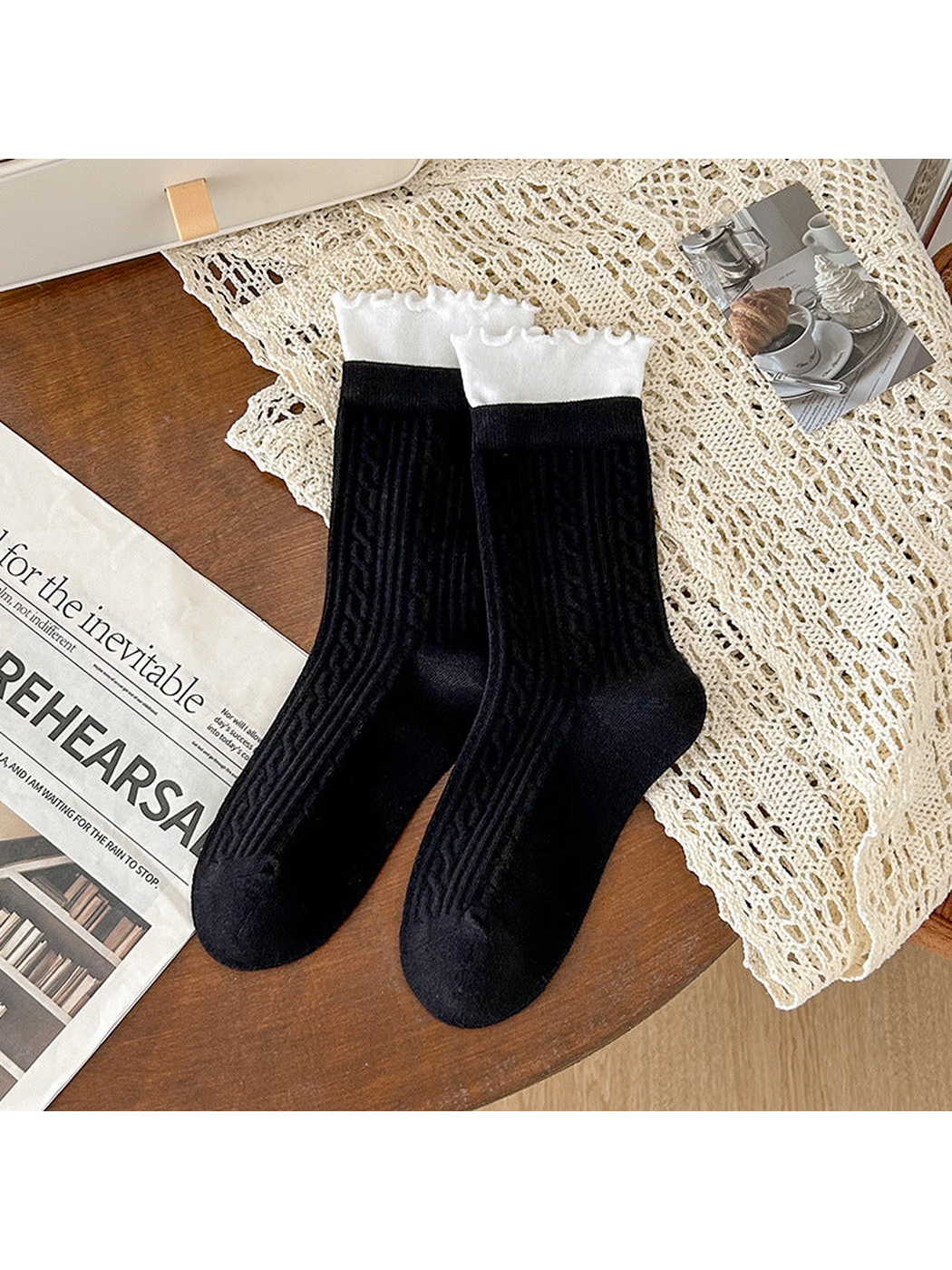Black crew socks with white ruffled cuffs and ribbed geometric texture