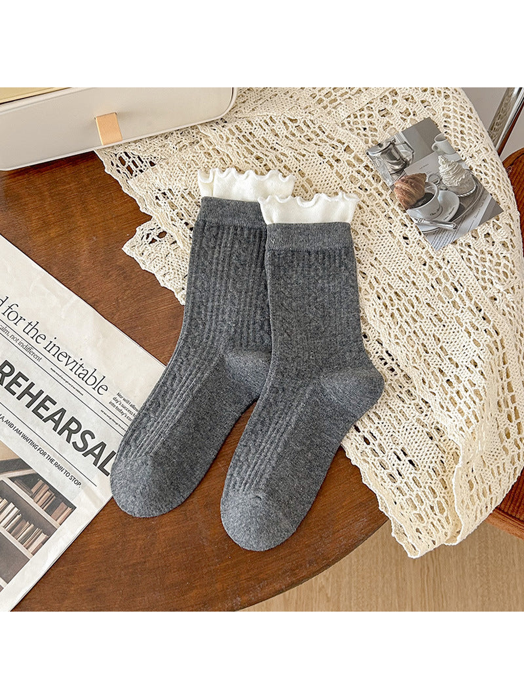 Dark gray crew socks with white ruffled cuffs and ribbed geometric texture