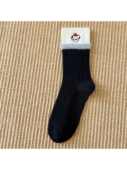 Black crew sock with white embroidered cuff and fuzzy trim