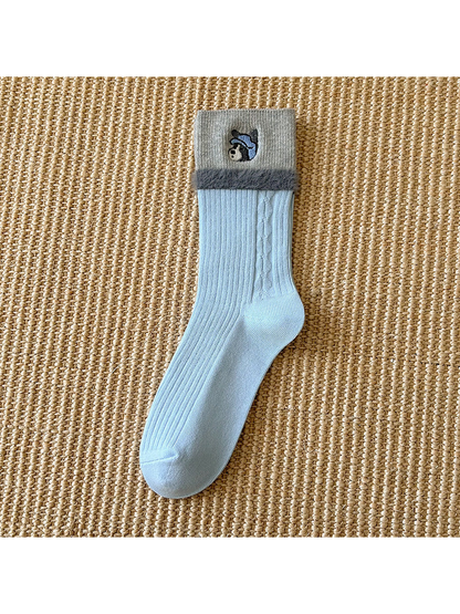 Light blue crew sock with gray embroidered cuff and fuzzy trim