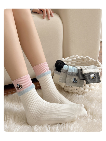 Ivory embroidered crew socks worn beside folded color options