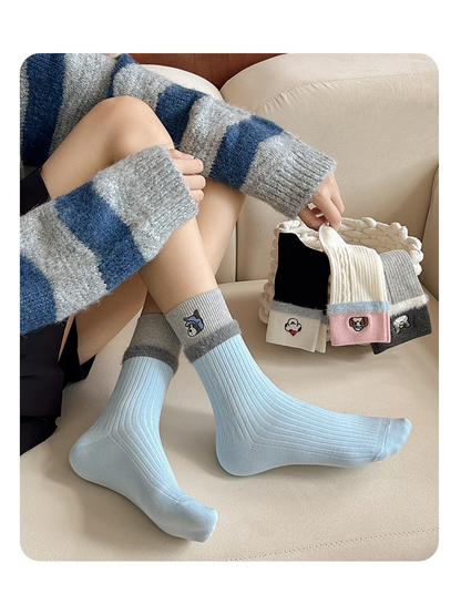 Light blue crew socks worn beside a basket of embroidered color options