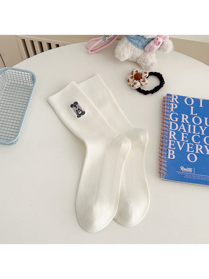 White ribbed crew socks with an embroidered gray animal motif