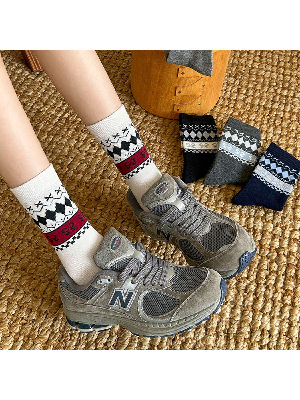 White patterned crew socks worn with gray sneakers beside additional color styles