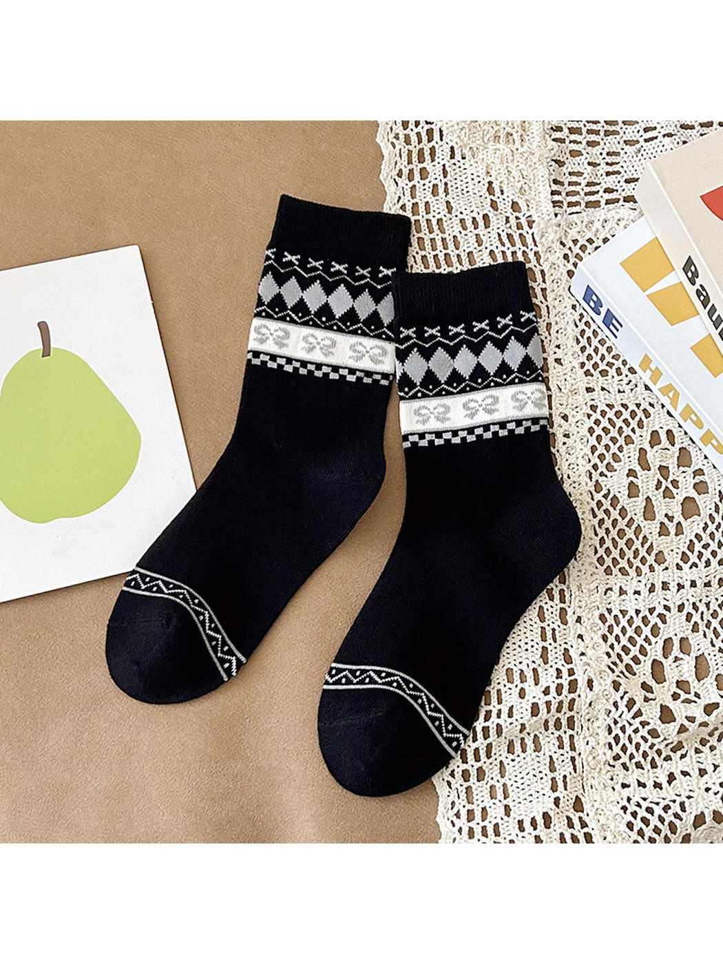Black crew socks with white and gray patterned cuffs