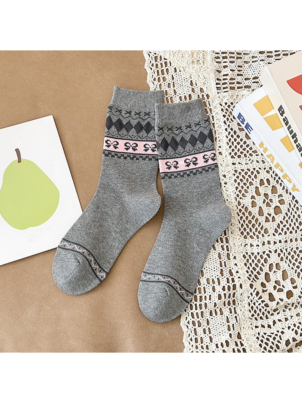 Heather gray crew socks with dark diamonds and a pink bow-patterned band