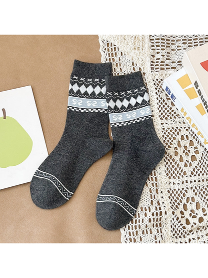 Dark gray crew socks with white diamonds and a pale gray bow-patterned band
