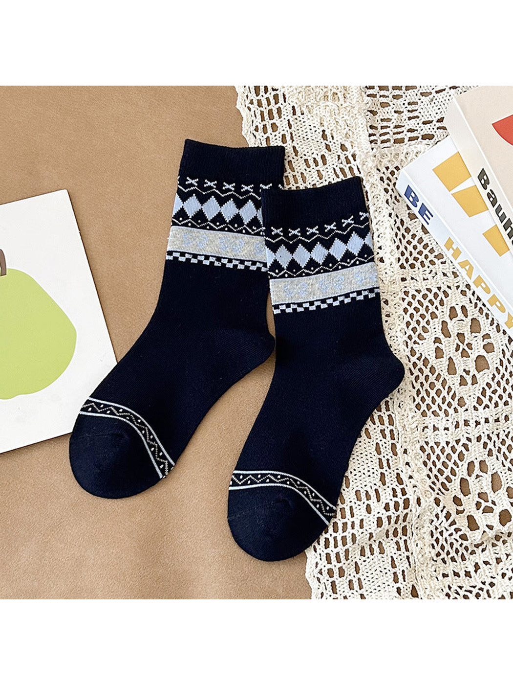 Navy crew socks with gray diamonds and a pale gray bow-patterned band