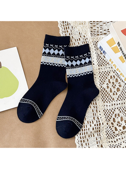 Navy crew socks with gray diamonds and a pale gray bow-patterned band