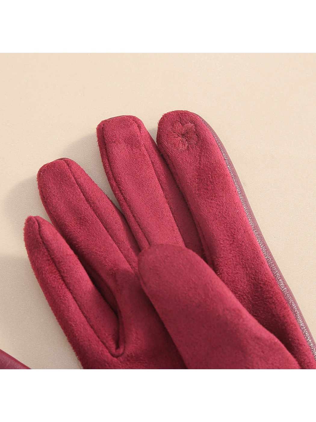 Close-up of the fuzzy inner finger surfaces on burgundy gloves