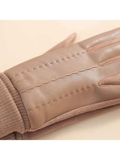 Close-up of decorative stitching and the wavy center seam on a camel glove