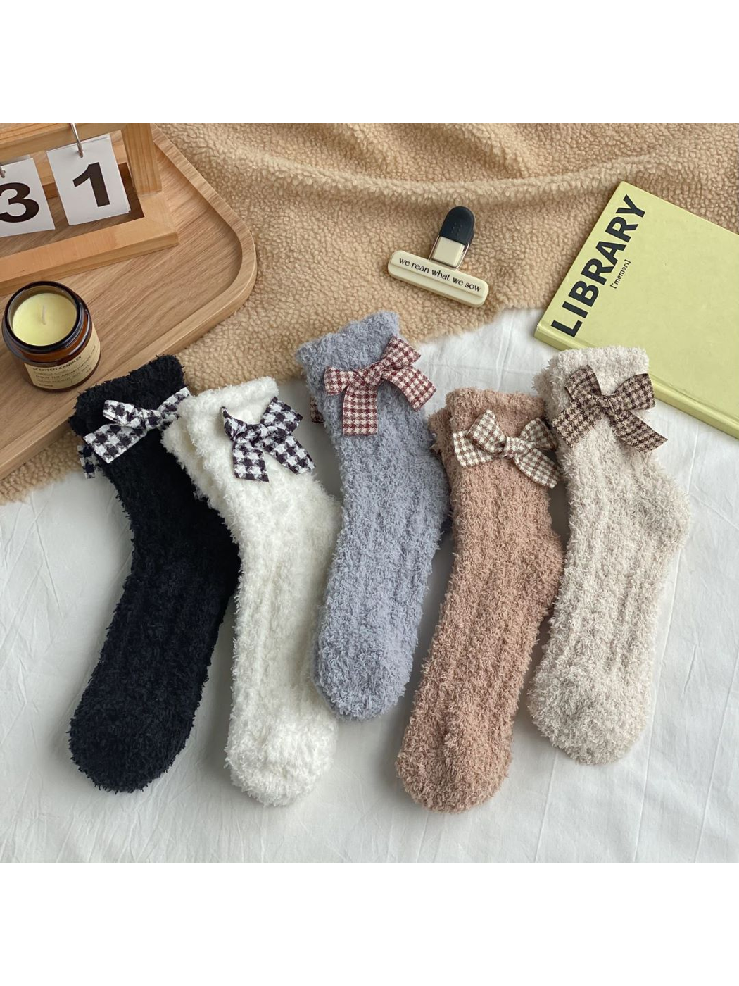 Five colors of fuzzy bow socks displayed together