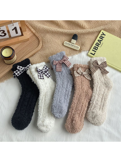 Five colors of fuzzy bow socks displayed together