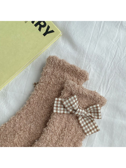 Close-up of the check bow positioned below the sock cuff