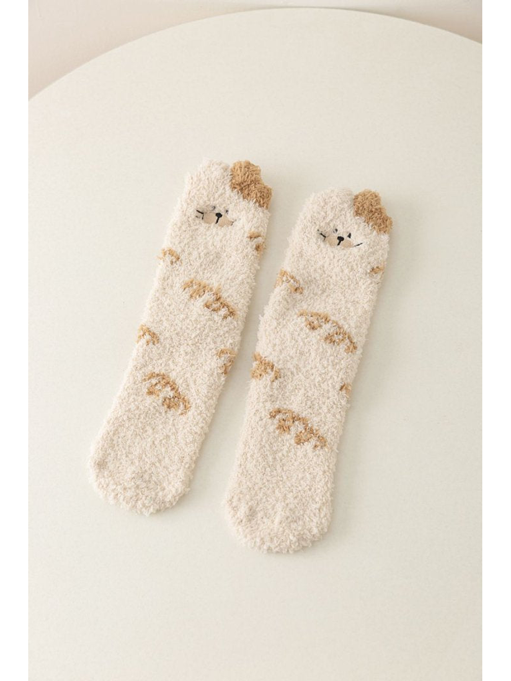 Ivory fuzzy crew socks with cat faces and beige markings