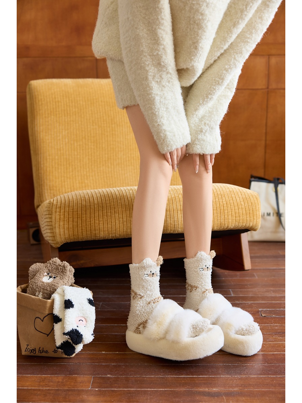 Ivory cat motif crew socks worn with plush slippers