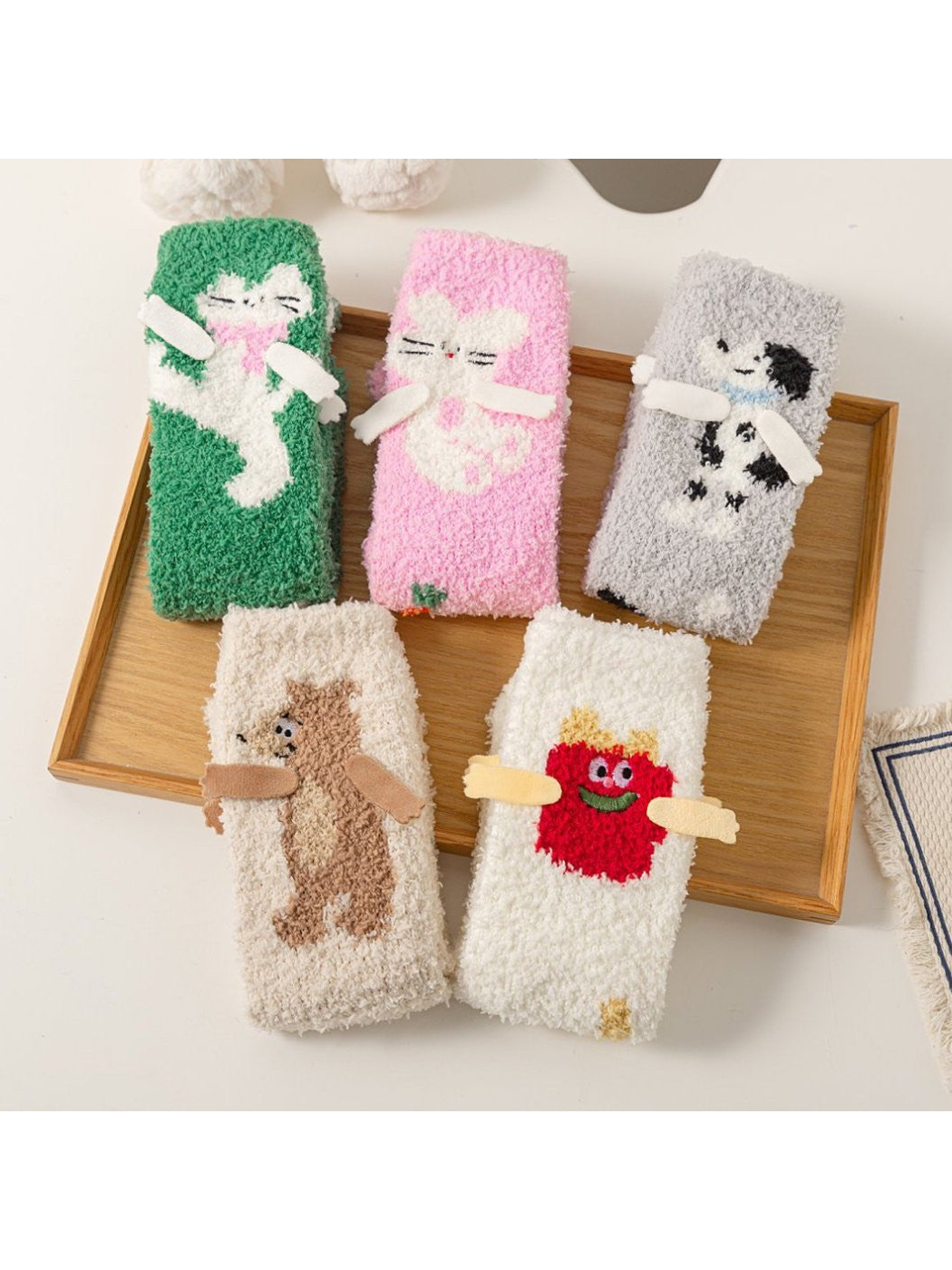 Five fuzzy crew sock styles with cat, dog, bear and character motifs