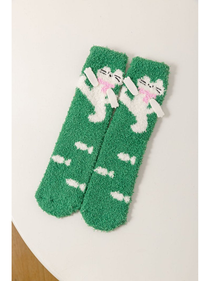 Green fuzzy crew socks with a white cat and candy motifs