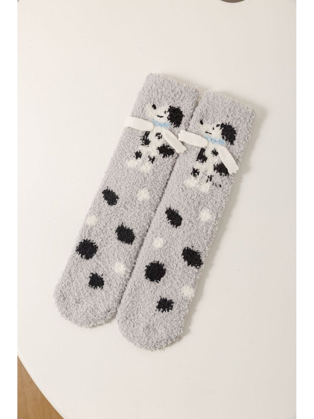 Gray fuzzy crew socks with a black-and-white dog and polka dots