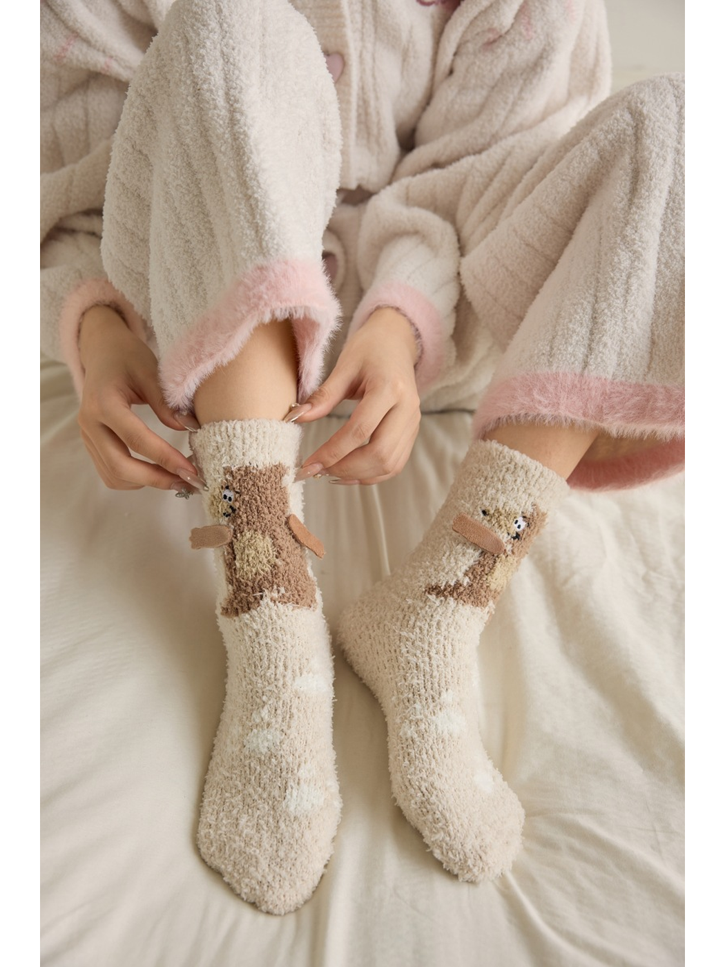 Beige bear crew socks worn while seated