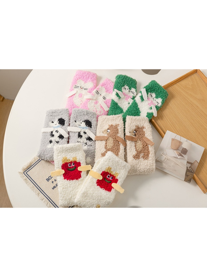 Five fuzzy character crew sock styles displayed as matching pairs